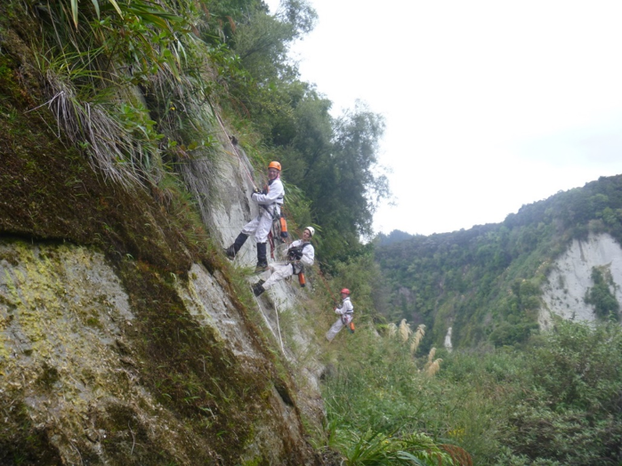 Three happy rope access workers completing conservation work.